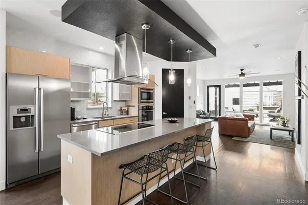 a kitchen with stainless steel appliances kitchen island granite countertop a table and chairs