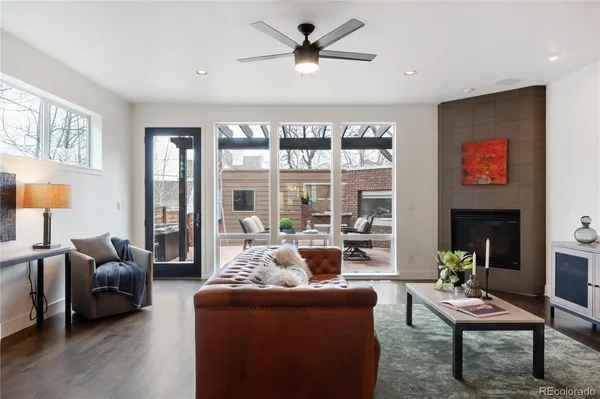 a living room with furniture a fireplace and a flat screen tv