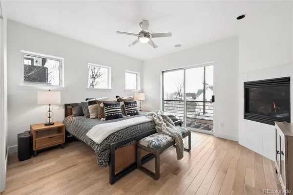 a bedroom with furniture and a large window