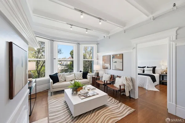 a living room with furniture couches and a large window