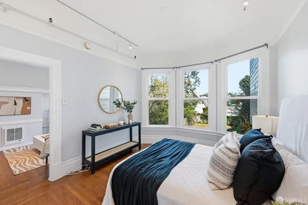 a bedroom with a bed and a large window