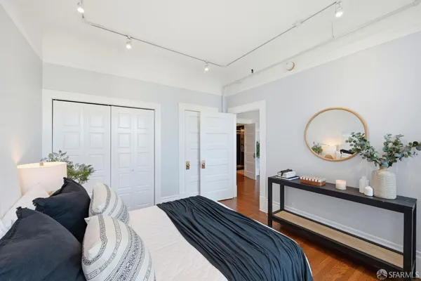 a bedroom with a bed and a mirror