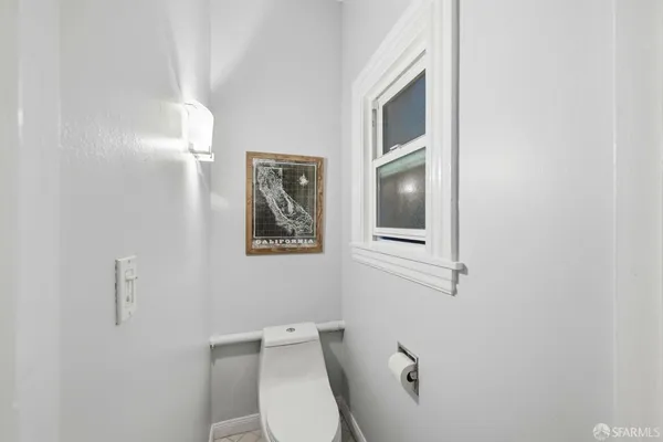 a white toilet sitting next to a bathroom sink