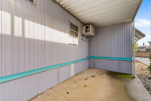 a view of a swimming pool with a table and chairs under an umbrella