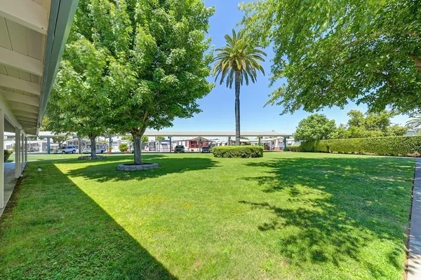 a view of yard with swimming pool and outdoor seating