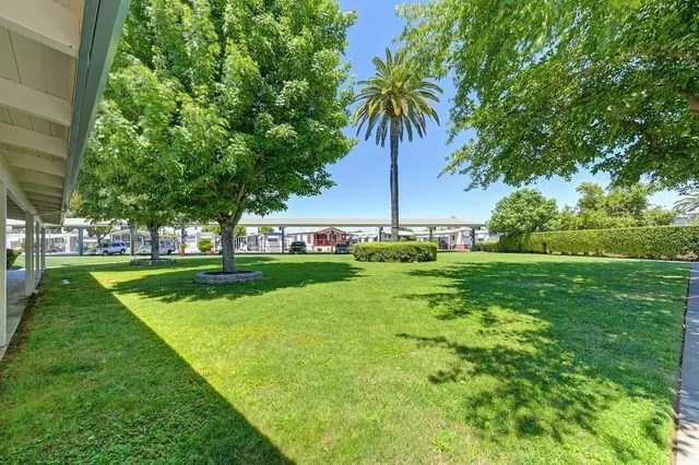 a view of yard with swimming pool and outdoor seating