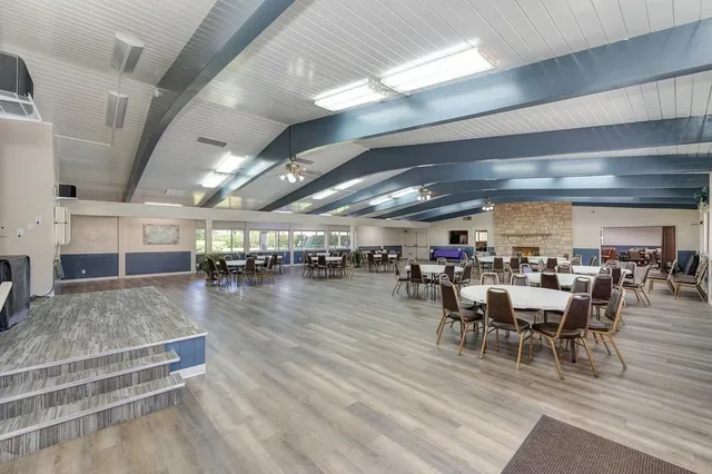 a room with pool table and windows