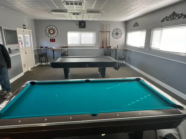 a view of a house with a yard and a garage