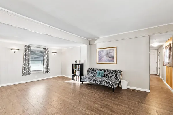 a kitchen with stainless steel appliances a stove a sink cabinets and wooden floor