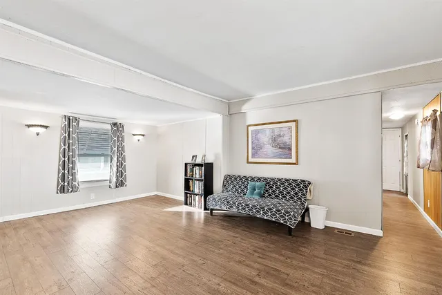 a kitchen with stainless steel appliances a stove a sink cabinets and wooden floor
