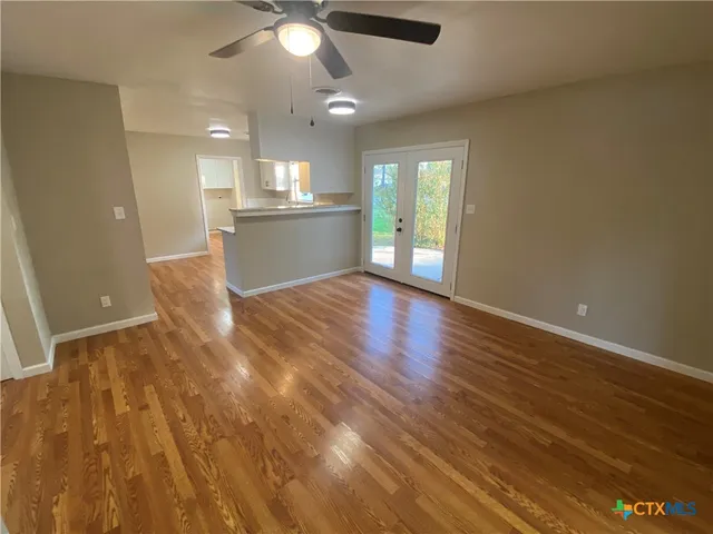 a view of kitchen and hall with wooden floor