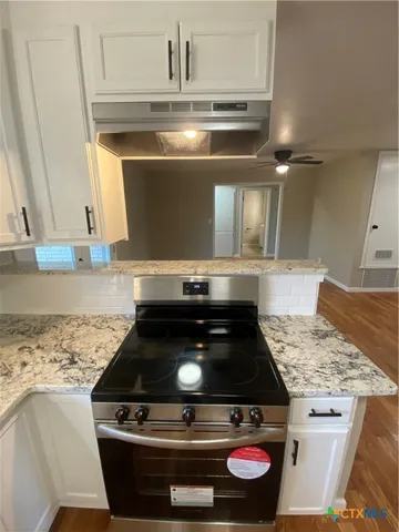 a stove top oven sitting inside of a kitchen