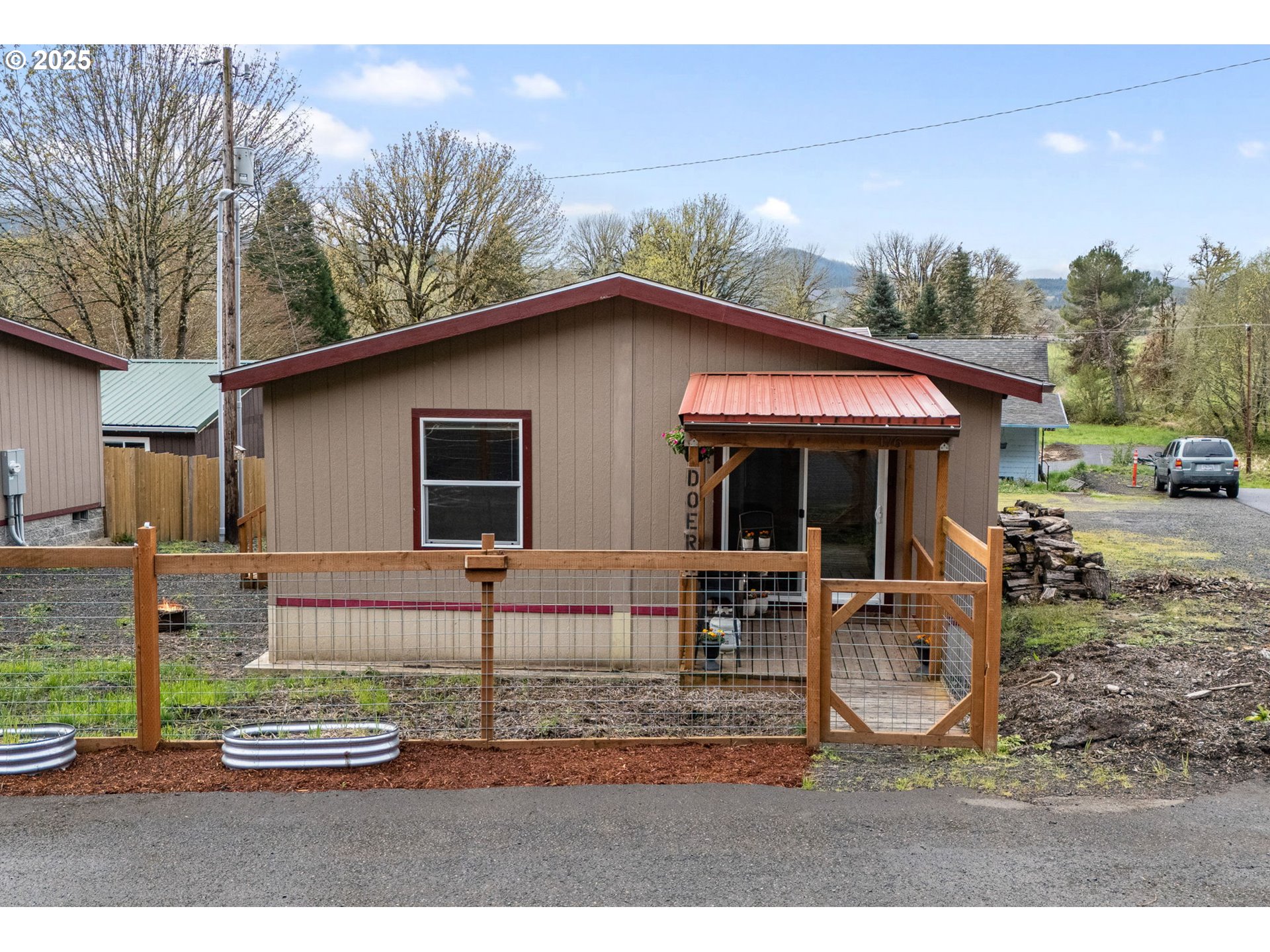 176 West Main Street Alsea, OR 97324 - Photo 1 of 16 a front view of a house with a garden