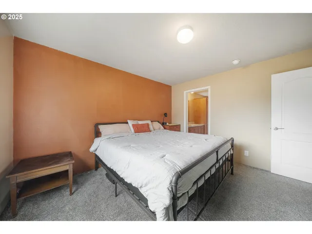 a bedroom with a bed and a desk