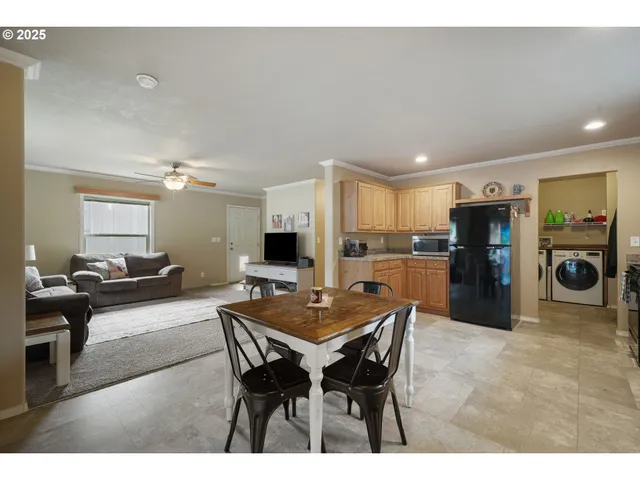 a living room with stainless steel appliances kitchen island granite countertop furniture and a view of kitchen