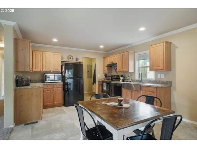 a kitchen with refrigerator cabinets and wooden floor