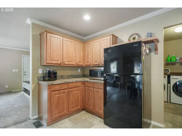 a kitchen with a refrigerator and a sink