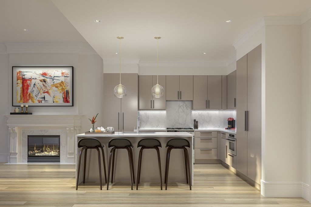 a kitchen with stainless steel appliances granite countertop a table chairs sink and cabinets