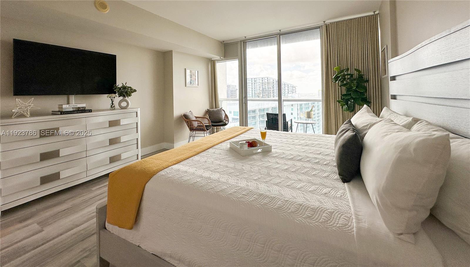 a bedroom with a bed and a flat screen tv