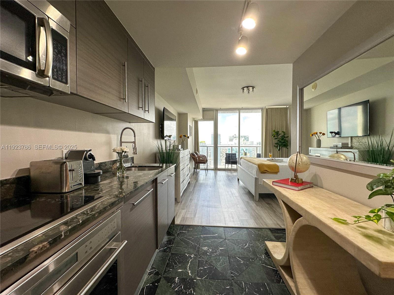 485 Brickell Avenue, Unit 4405 Miami, FL 33131 - Photo 12 of 19 a large kitchen with stainless steel appliances granite countertop a lot of counter space and a sink
