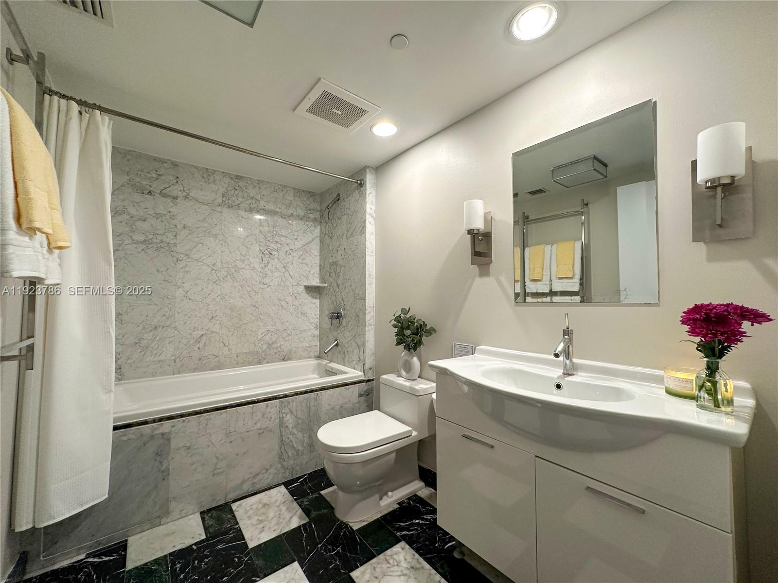 485 Brickell Avenue, Unit 4405 Miami, FL 33131 - Photo 13 of 19 a bathroom with a sink toilet and shower
