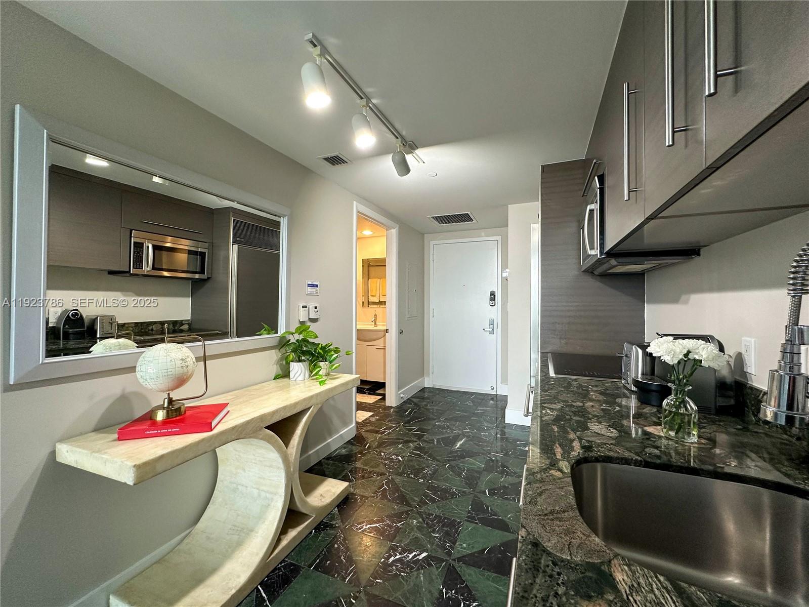 485 Brickell Avenue, Unit 4405 Miami, FL 33131 - Photo 14 of 19 a living room with furniture and a flat screen tv