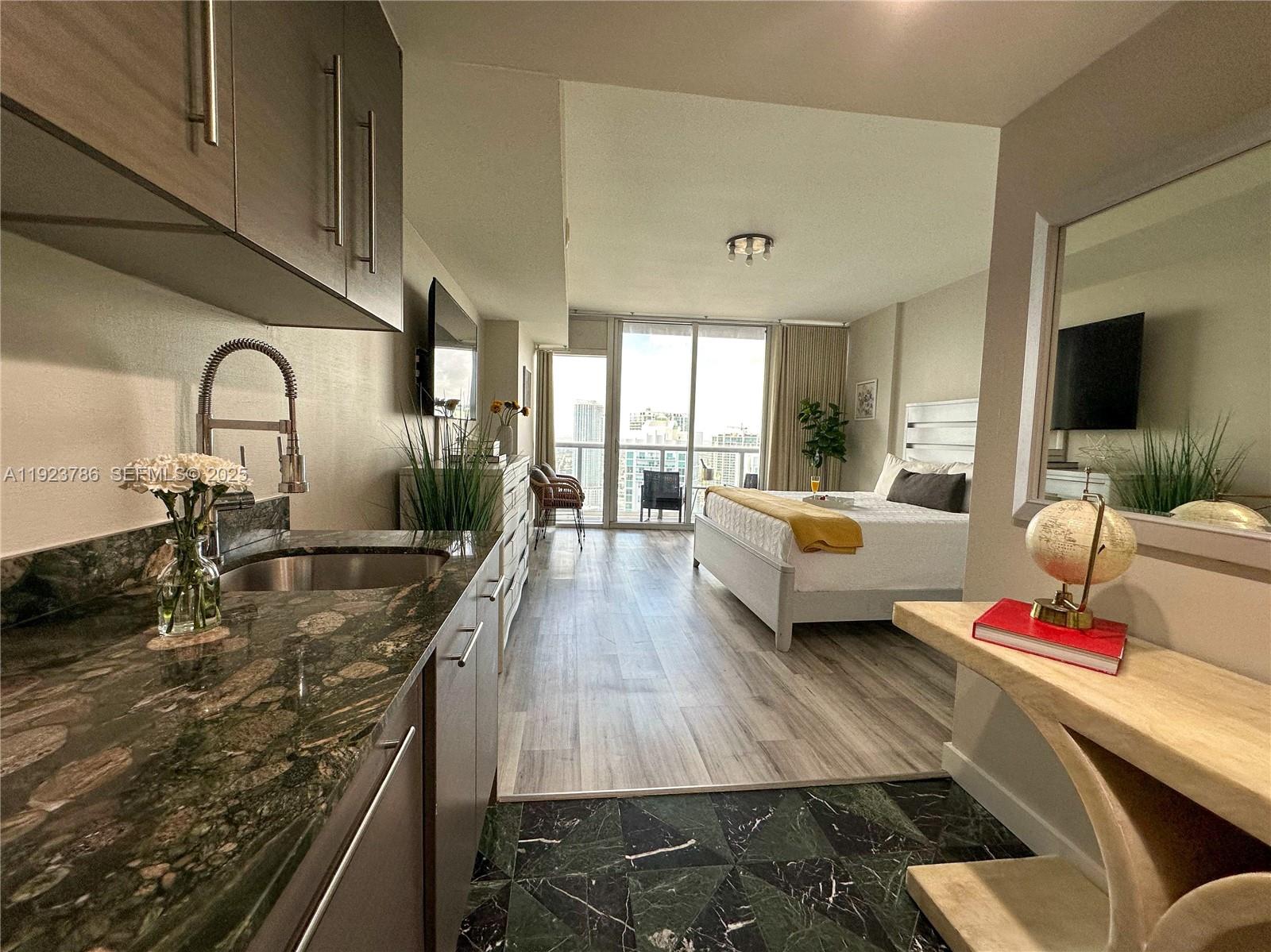 485 Brickell Avenue, Unit 4405 Miami, FL 33131 - Photo 9 of 19 a living room with furniture and flat screen tv