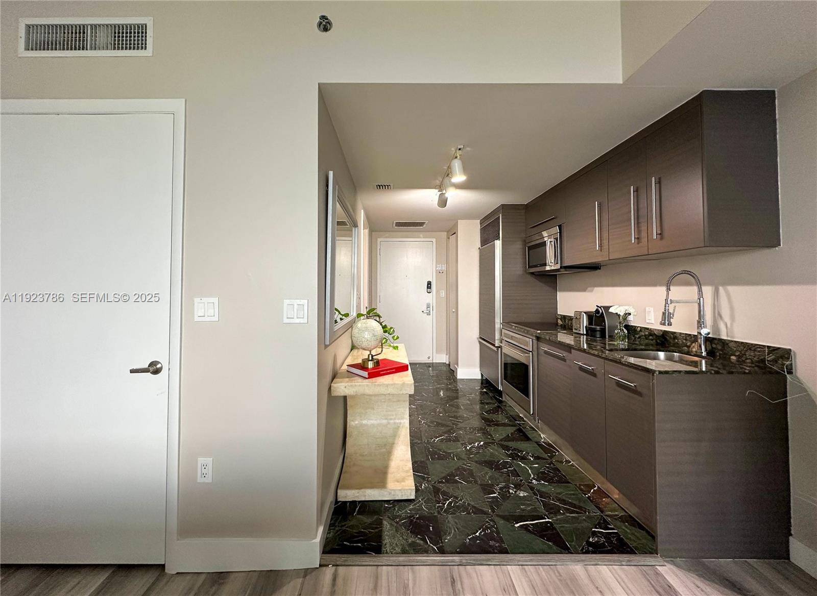 485 Brickell Avenue, Unit 4405 Miami, FL 33131 - Photo 10 of 19 a kitchen with granite countertop a refrigerator and a stove