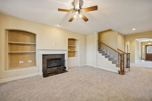 a view of empty room with fireplace and fan