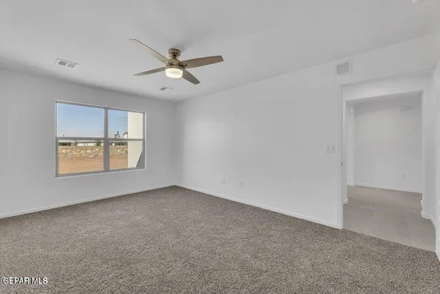 a view of a kitchen with furniture and a ceiling fan