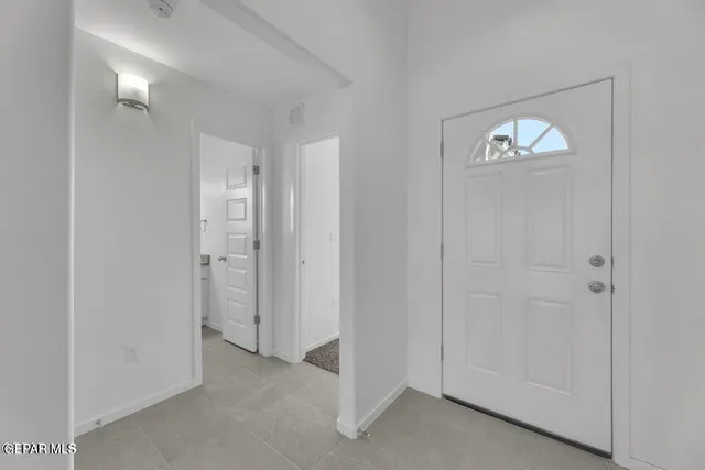 an empty room with windows and closet