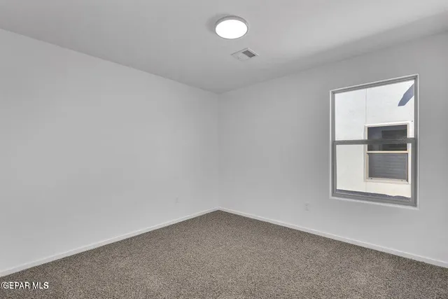 an empty room with a empty space and a ceiling fan