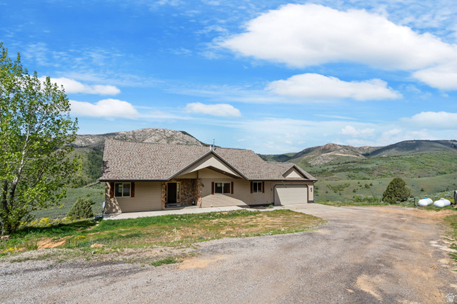 2013 North River View Road Huntsville, UT 84317 - Photo 43 of 53 Single story home with driveway, a mountain view, and an attached garage