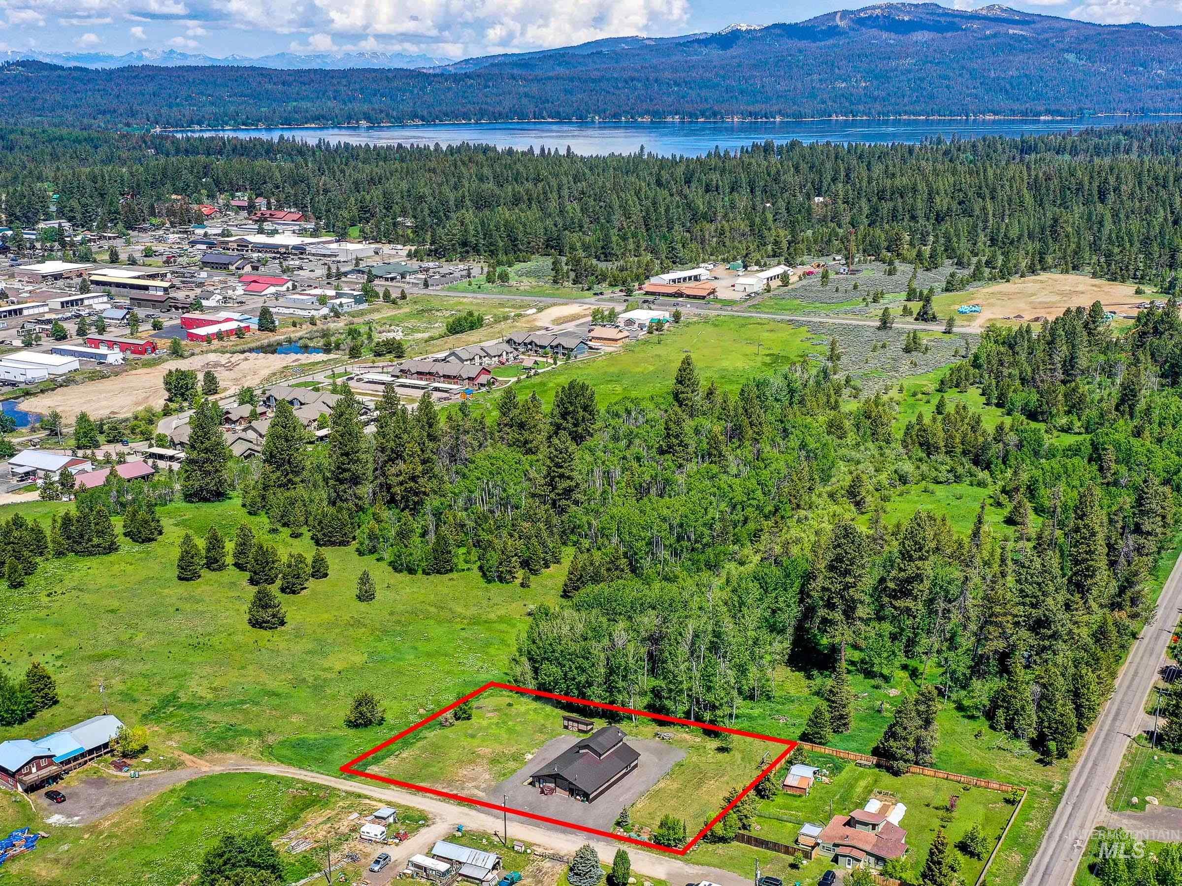 Aerial overview of property's location with property boundaries highlighted and a water and mountain view