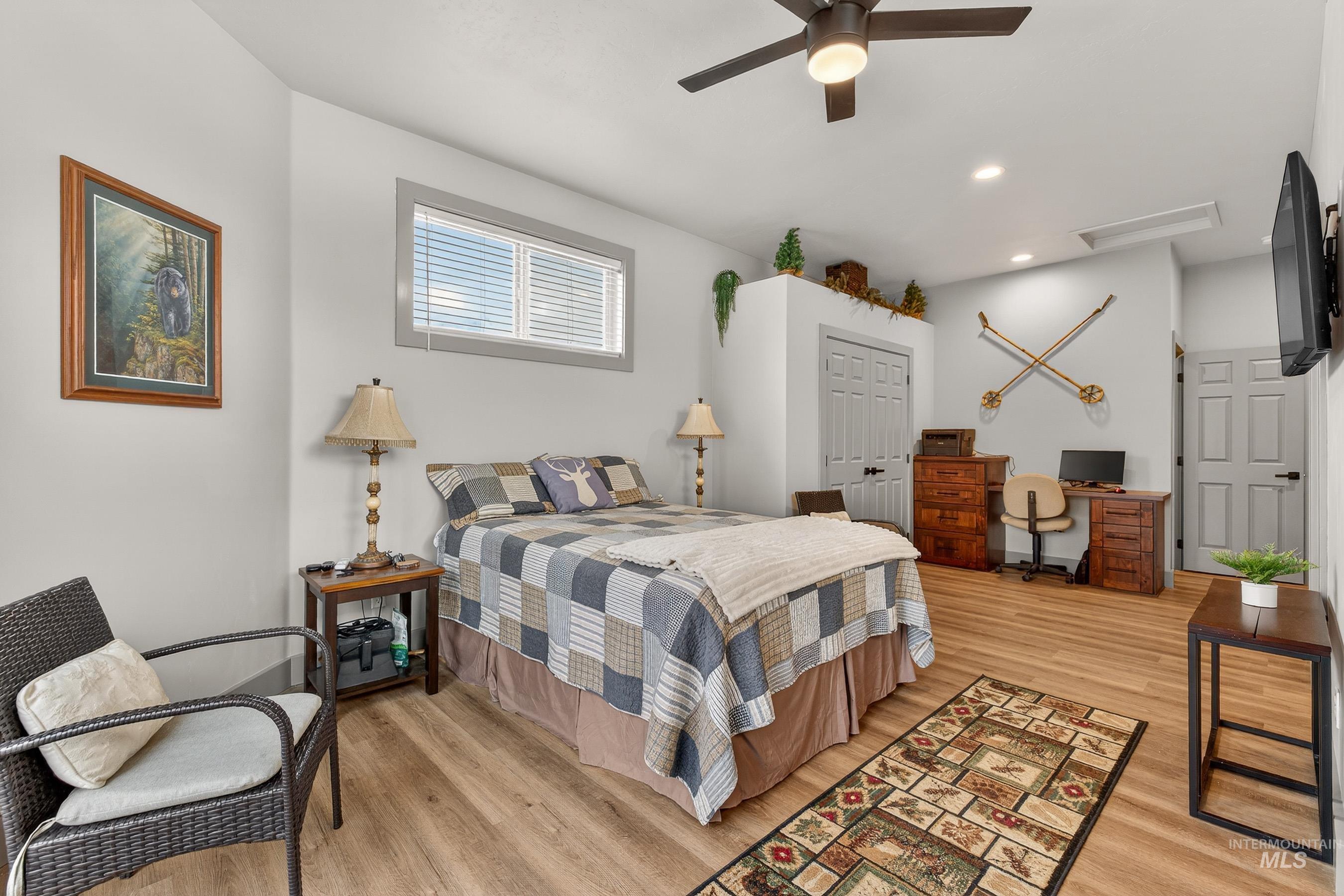 304 Samson Court, Unit 656 McCall, ID 83638 - Photo 14 of 29 Bedroom featuring light wood-style floors, an office area, ceiling fan, a closet, and recessed lighting