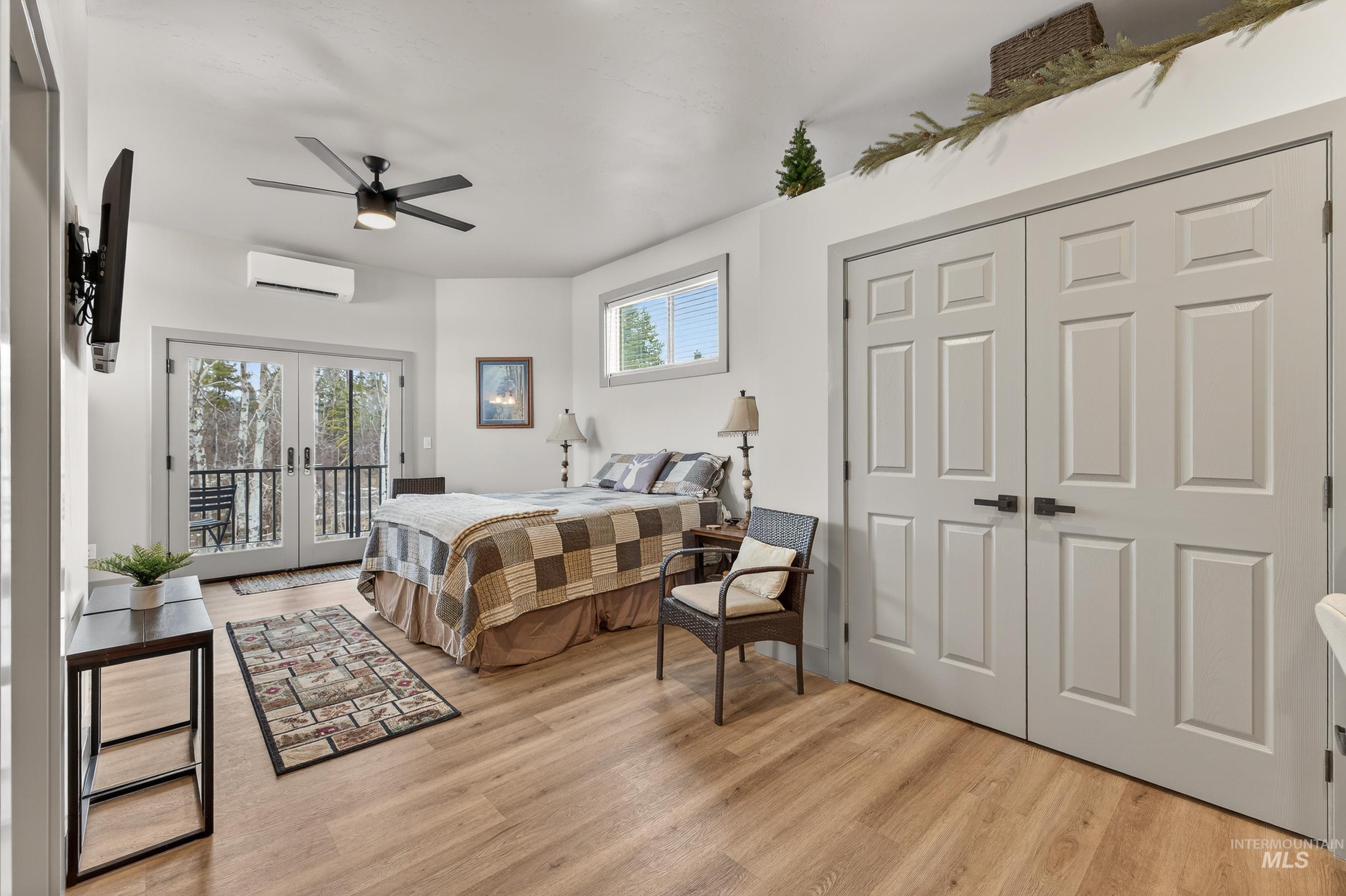 304 Samson Court, Unit 656 McCall, ID 83638 - Photo 15 of 29 Bedroom featuring french doors, light wood-style flooring, access to outside, and a ceiling fan