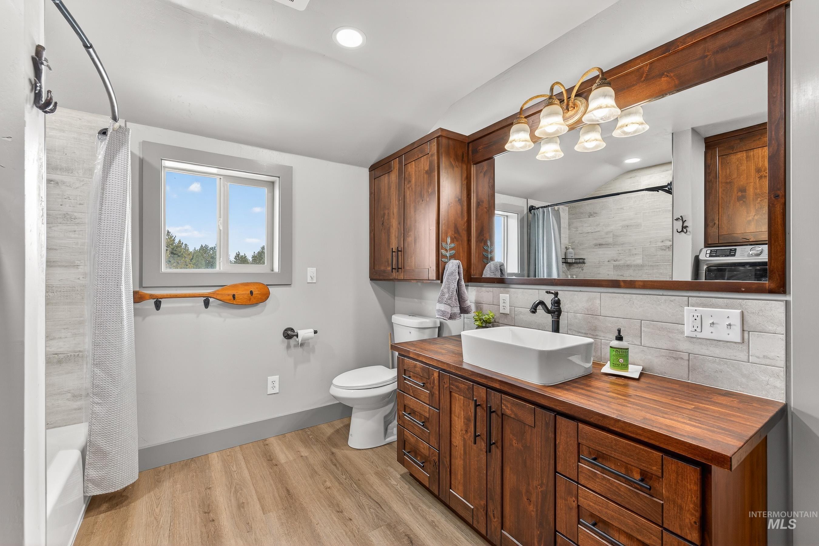 304 Samson Court, Unit 656 McCall, ID 83638 - Photo 16 of 29 Full bathroom with backsplash, vanity, light wood-style flooring, healthy amount of natural light, and recessed lighting