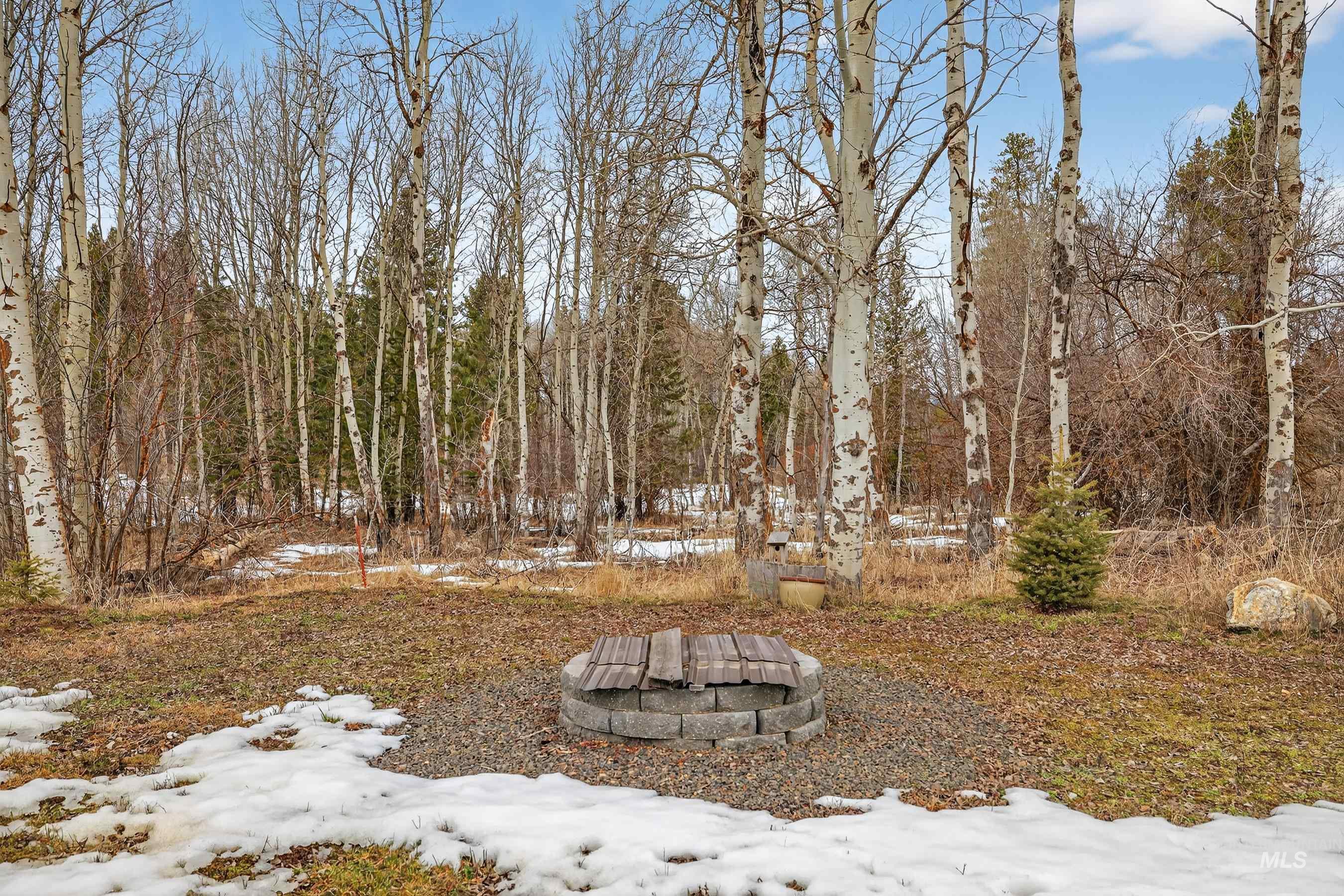 304 Samson Court, Unit 656 McCall, ID 83638 - Photo 24 of 29 Snowy yard featuring an outdoor fire pit