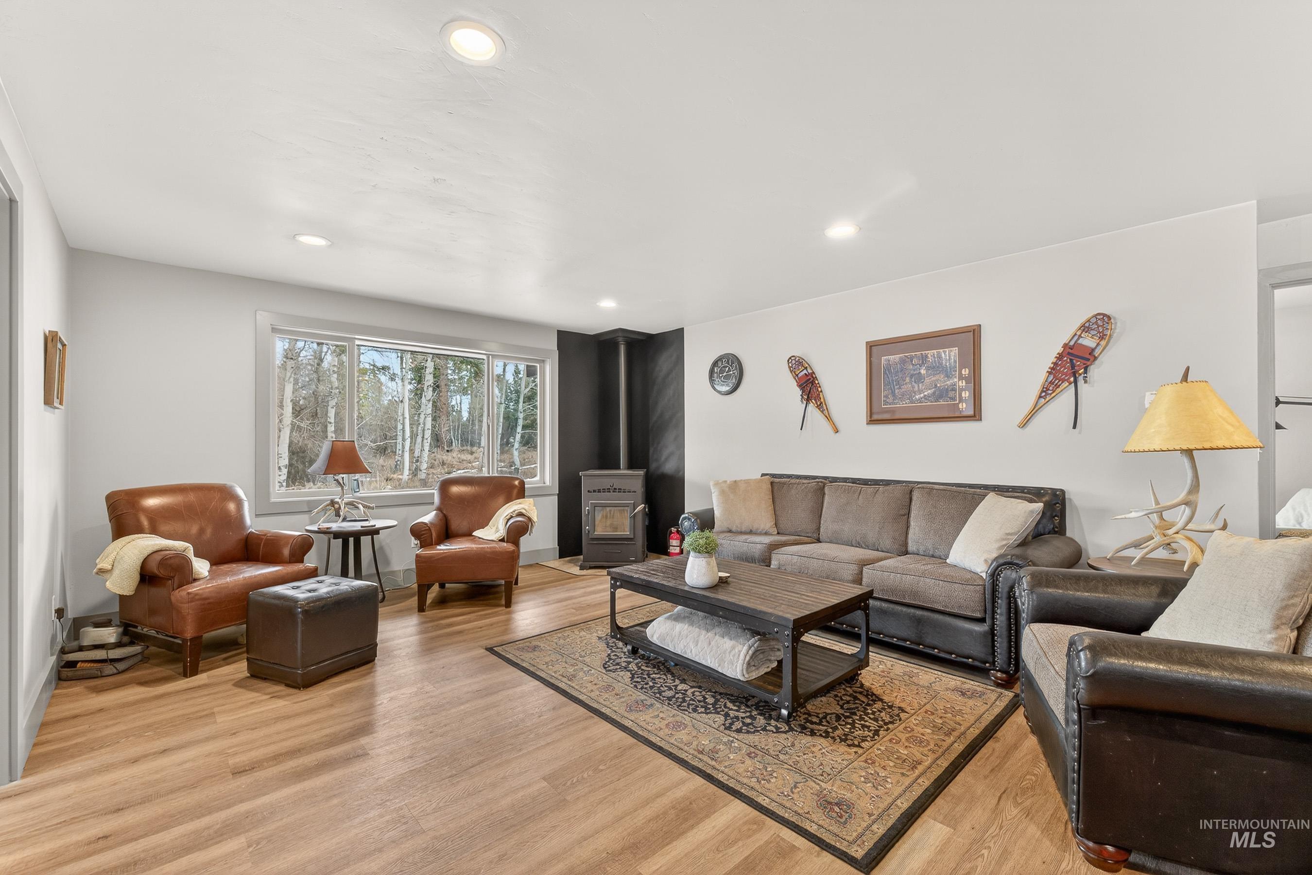 304 Samson Court, Unit 656 McCall, ID 83638 - Photo 5 of 29 Living room with a wood stove, light wood finished floors, and recessed lighting