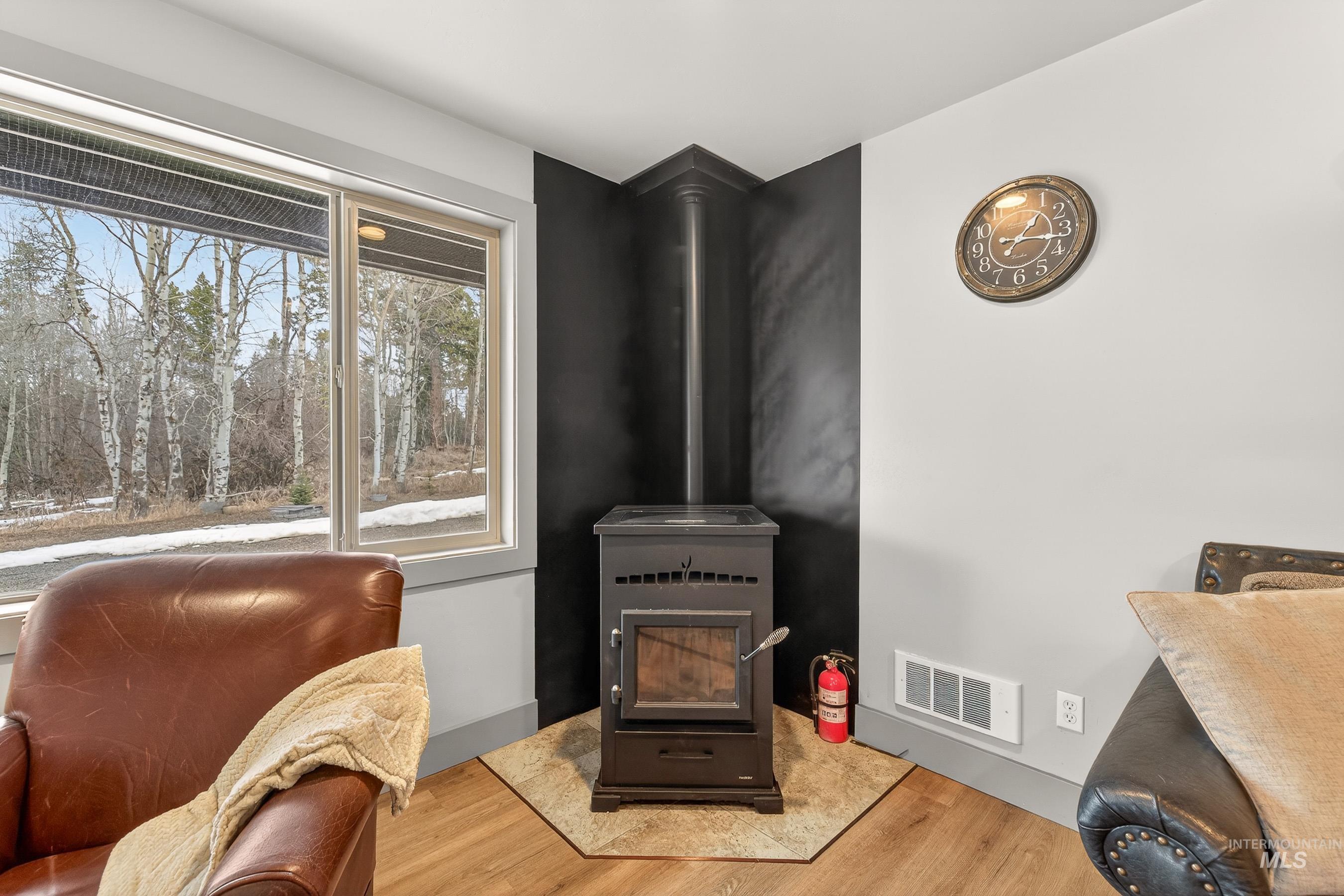 304 Samson Court, Unit 656 McCall, ID 83638 - Photo 6 of 29 Sitting room featuring a wood stove and light wood-type flooring