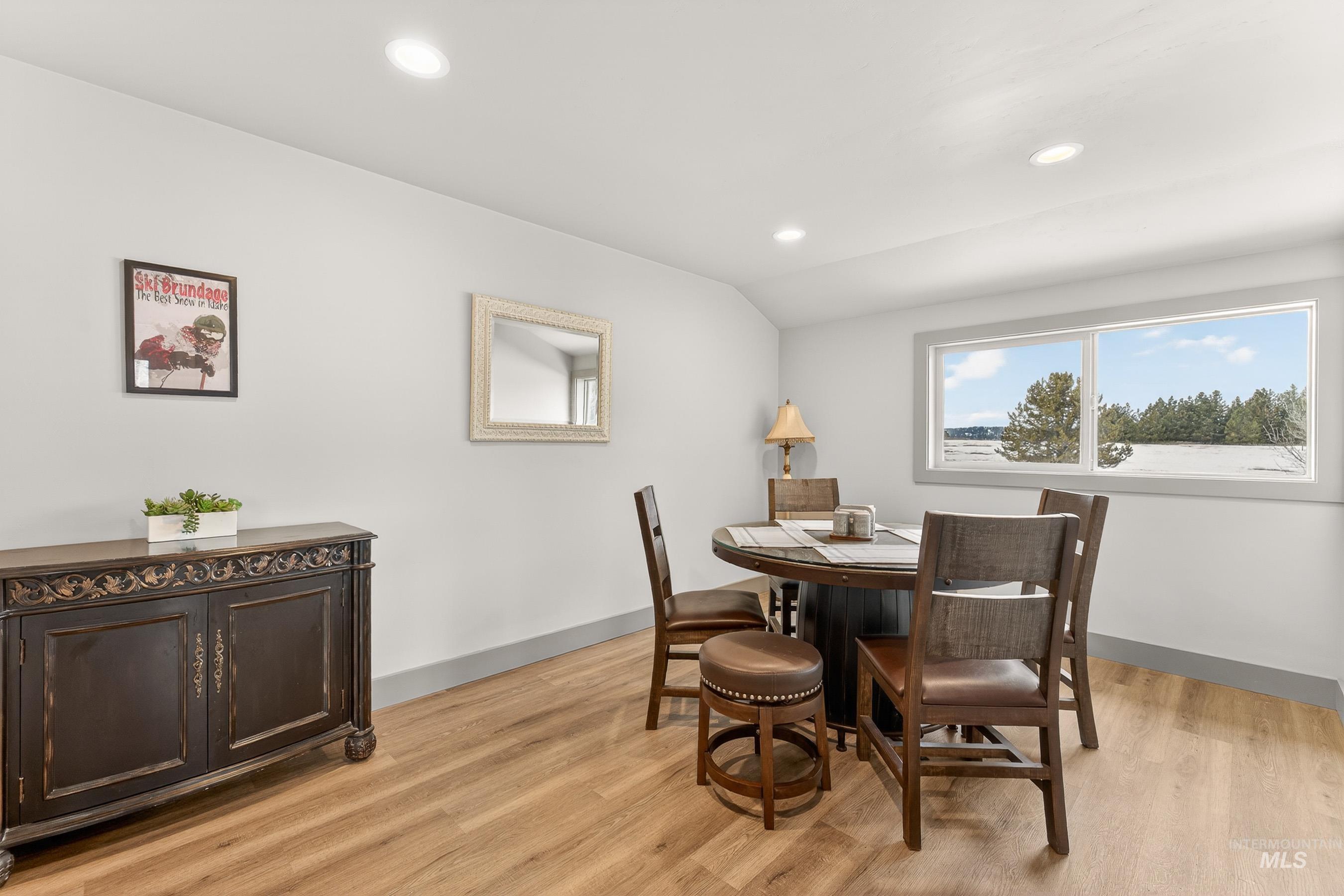 304 Samson Court, Unit 656 McCall, ID 83638 - Photo 7 of 29 Dining area with vaulted ceiling, light wood-style floors, and recessed lighting