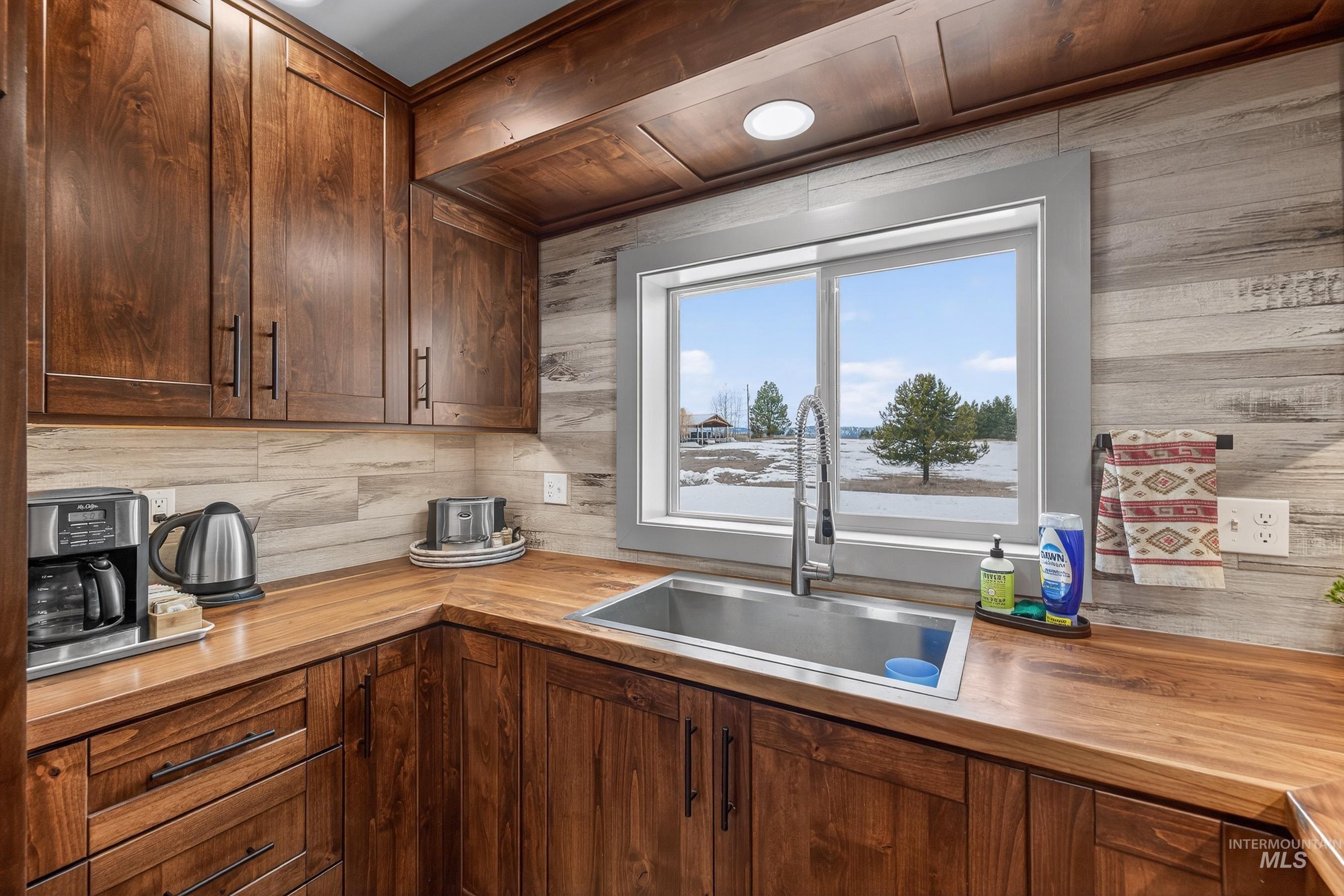 304 Samson Court, Unit 656 McCall, ID 83638 - Photo 10 of 29 Kitchen featuring wood counters, dark wood finish cabinetry, and decorative backsplash