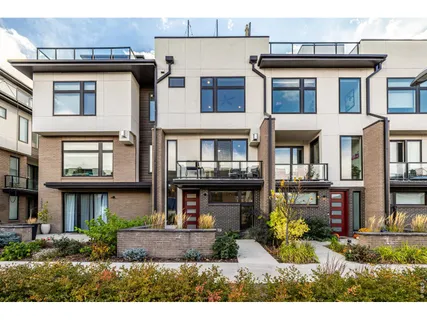 a front view of a residential apartment building with a yard