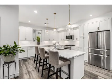 a kitchen with a table and chairs in it