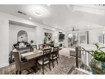 a living room with furniture a rug and a floor to ceiling window