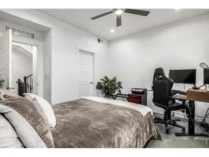 a bedroom with a bed and a chair