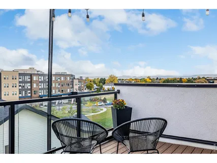 a balcony with a table and chairs