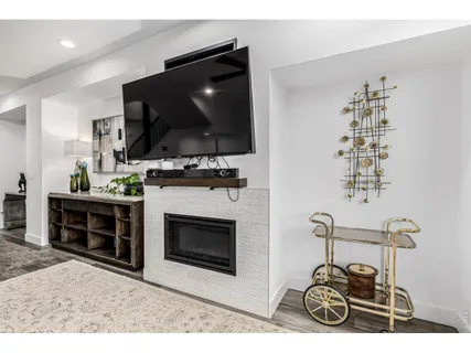 a living room with a fireplace and a flat screen tv