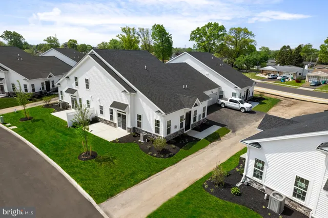 an aerial view of residential houses with yard
