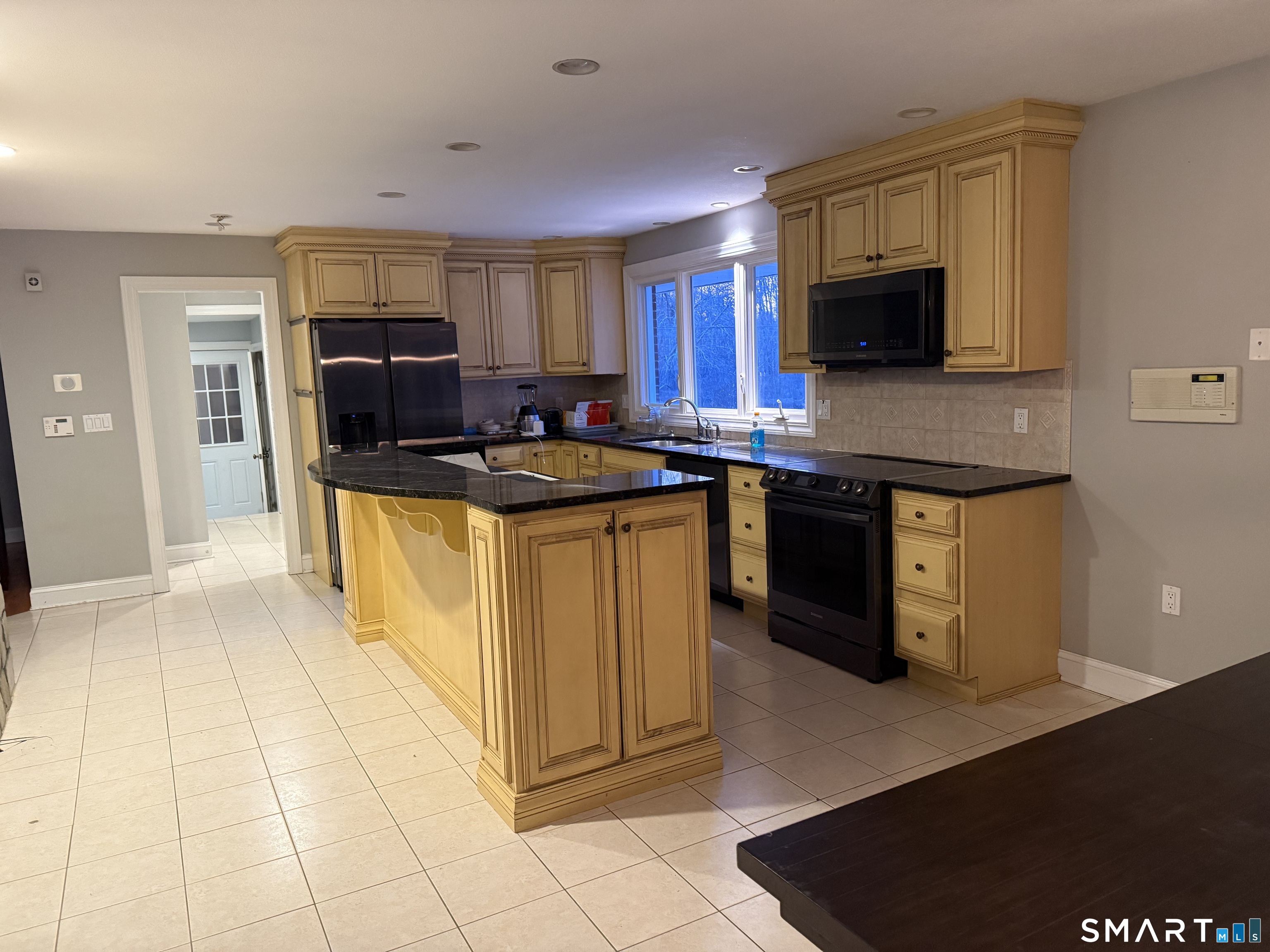 10 Hillcrest Drive Waterford, CT 06385 - Photo 6 of 6 a kitchen with stainless steel appliances granite countertop a stove a sink and a microwave